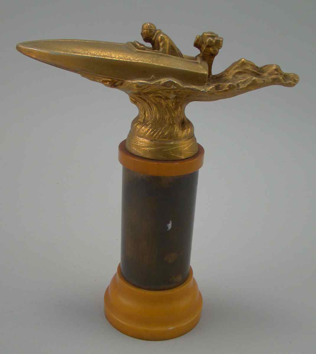 Appraisal: METAL AND BAKELITE SPEEDBOAT TROPHY Gold-painted metal with bakelite base