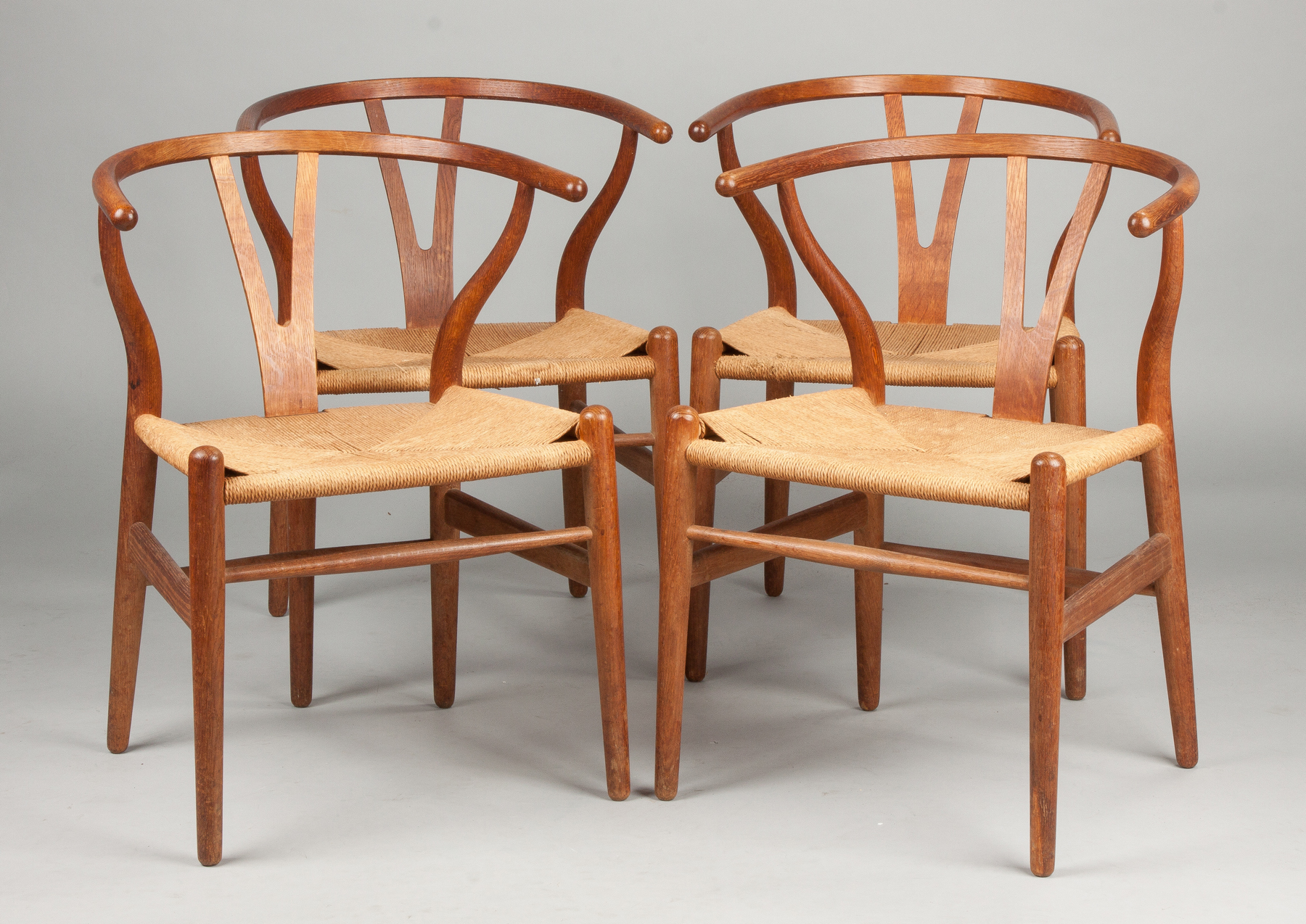 Appraisal: Hans Wegner Set of Four Wishbone Chairs Walnut Grass seats