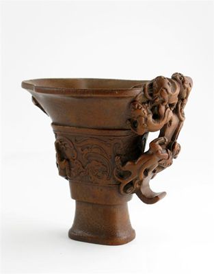 Appraisal: A Chinese bamboo libation cup the handle elaborately carved with