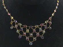 Appraisal: A multi gem tourmaline and garnet necklace set in yellow