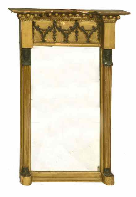 Appraisal: A REGENCY GILTWOOD HANGING WALL MIRROR with Egyptian figure pilasters