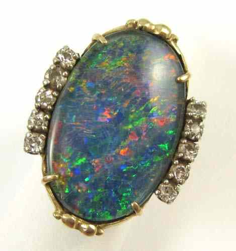 Appraisal: BLACK OPAL DOUBLET AND DIAMOND RING k yellow gold featuring