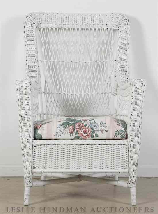 Appraisal: A Painted Wicker Armchair raised on four legs joined by