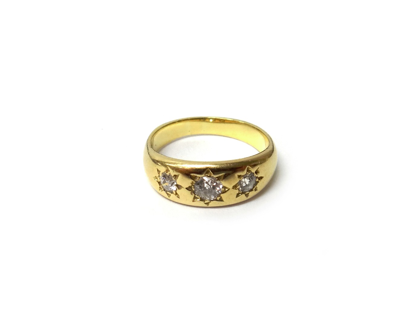 Appraisal: A gold and diamond three stone ring mounted with a