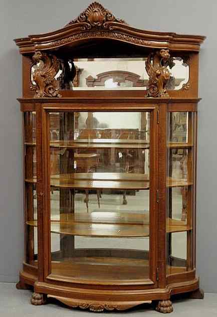 Appraisal: Fine oak bow-front china cabinet c with carved griffins and