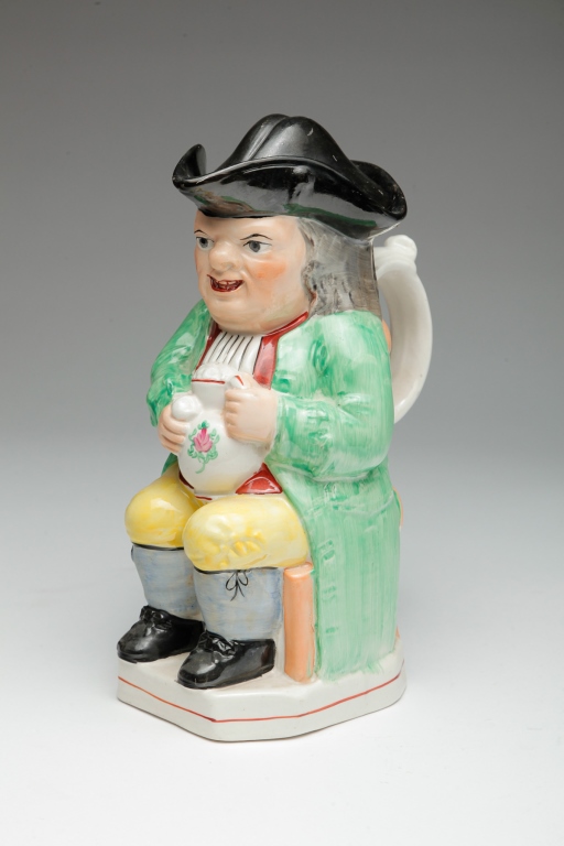 Appraisal: Mid th century Seated man with jug in tricorner hat