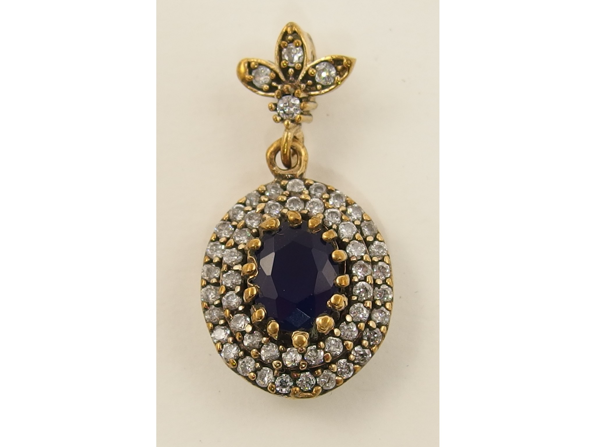 Appraisal: A bronze white metal blue gem and white topaz pendant