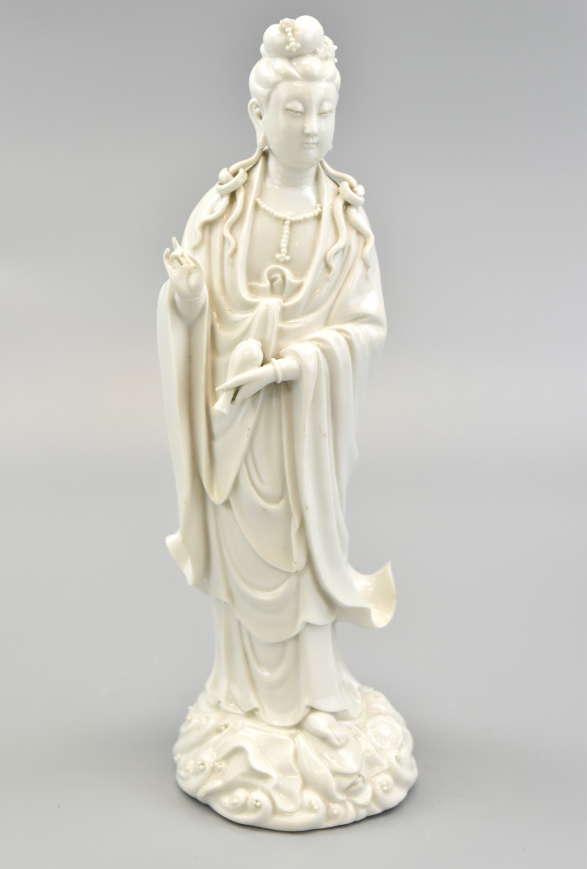 Appraisal: A porcelain figure of the Bodhisattva Guan Yin wearing her