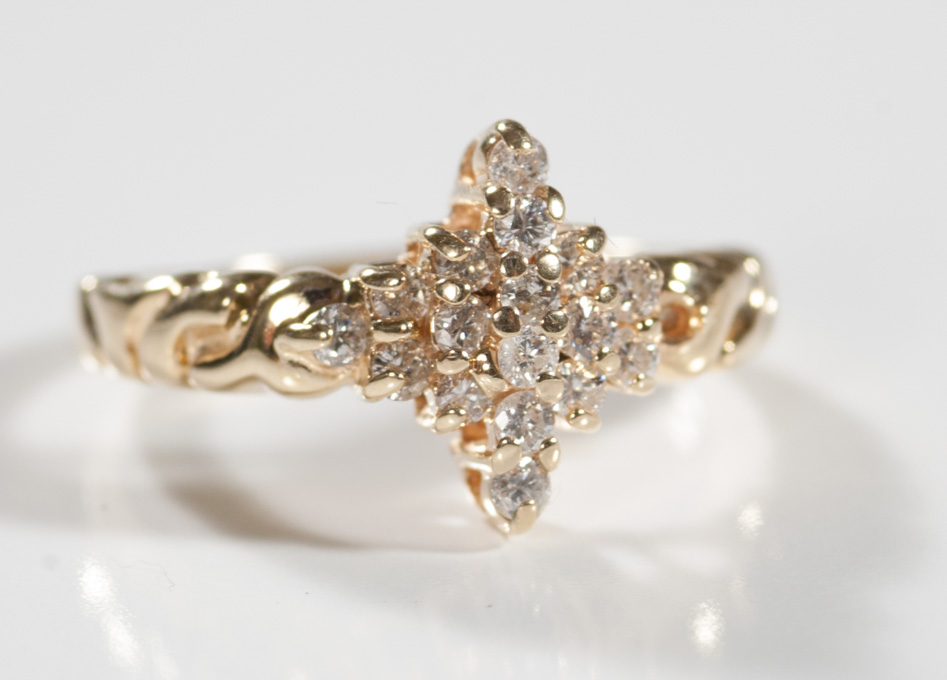 Appraisal: DIAMOND AND FOURTEEN KARAT GOLD RING set with round-cut diamonds