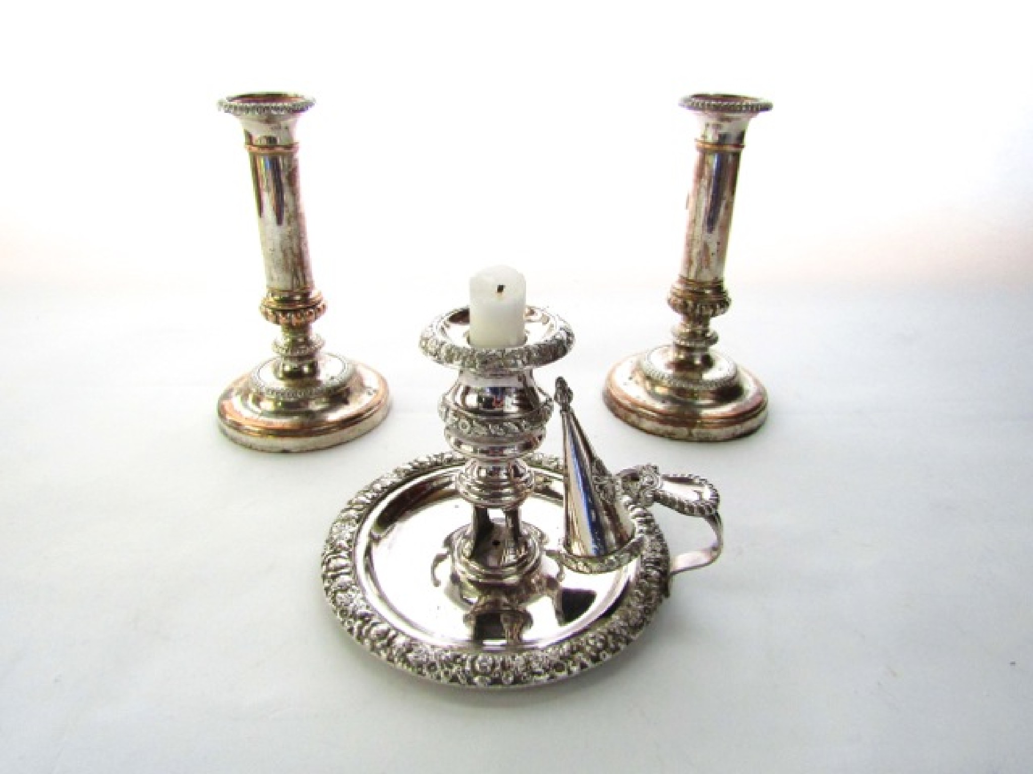 Appraisal: A pair of antique silver plated candlesticks with embossed borders