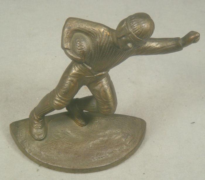 Appraisal: Cast iron doorstop early football player in uniform on matching