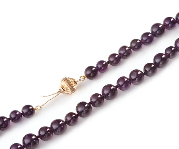 Appraisal: A strand of spherical amethyst beads measuring - mm length