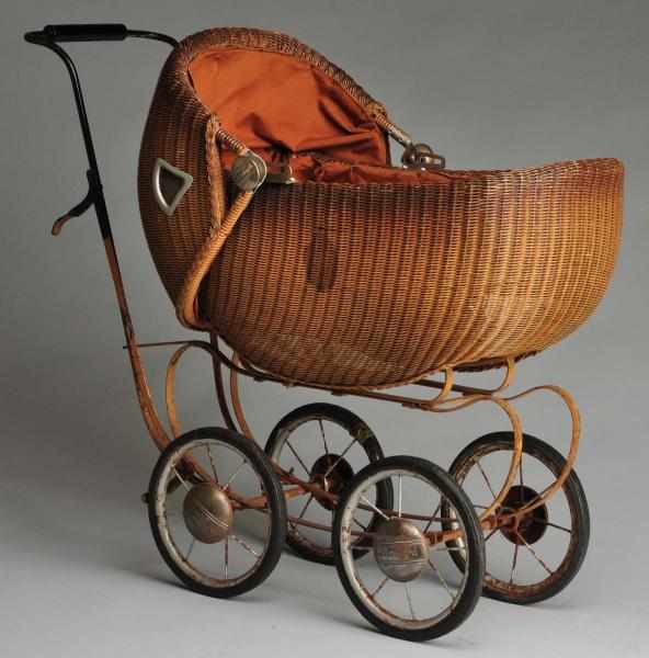 Appraisal: Shirley Temple Wicker Doll Carriage Description Brown wicker with hood