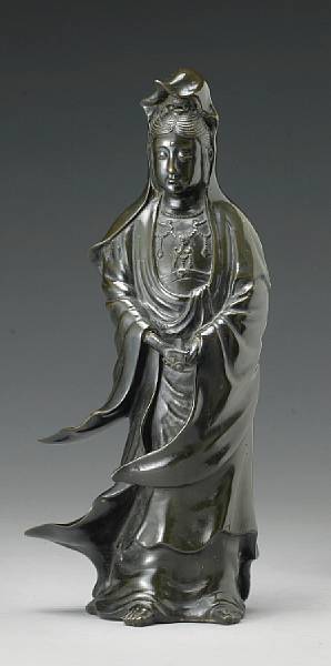 Appraisal: A bronze standing figure of Kannon The figure shown holding