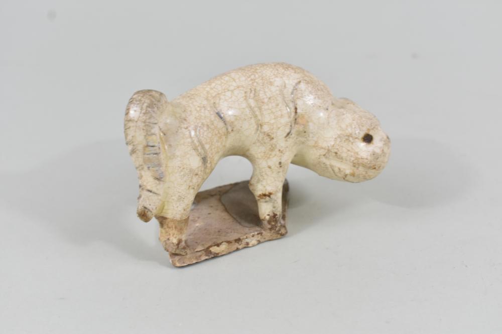 Appraisal: CHINESE CREAM GLAZED POTTERY TIGERPossibly Tang Dynasty The fine crackle