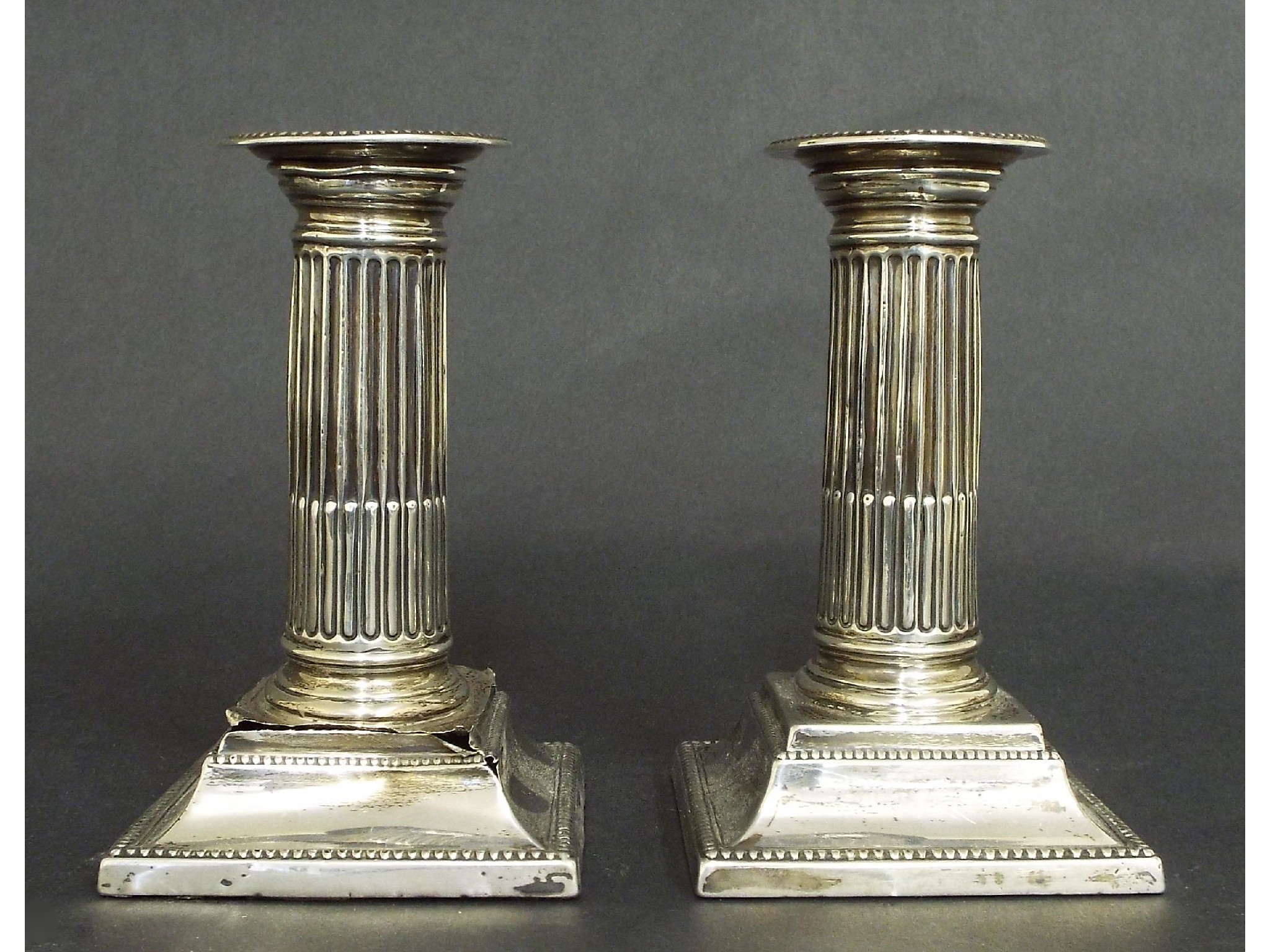 Appraisal: Pair of late Victorian silver Corinthian column candlesticks with beaded