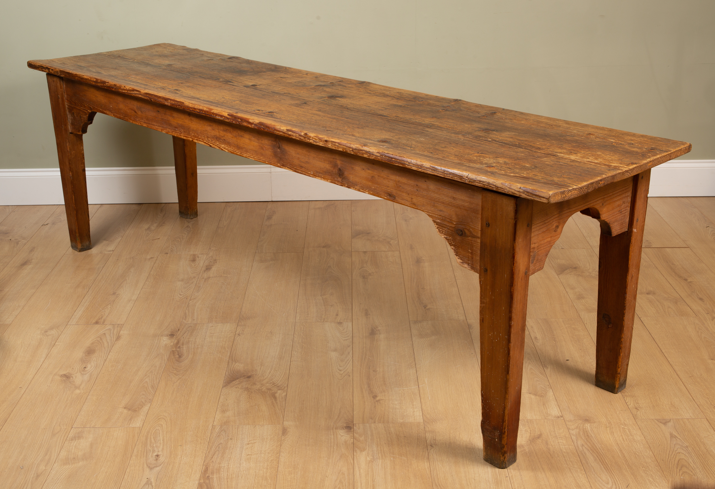 Appraisal: An antique pine kitchen table standing on square tapering legs