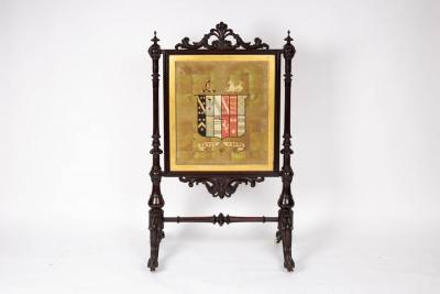 Appraisal: A Victorian armorial fire screen the needlework panel with the