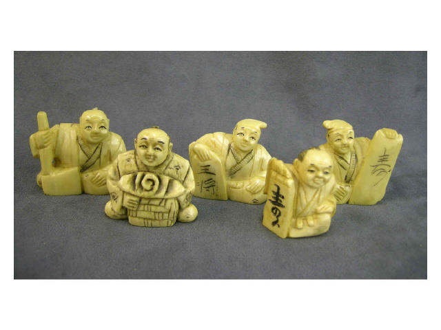 Appraisal: Five flat ivory seated netsuke three depicting men holding tablets