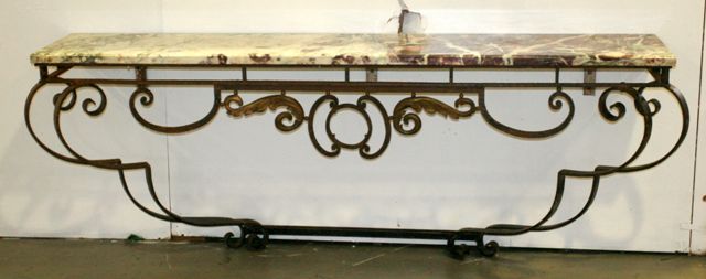 Appraisal: A French style wrought iron console table with a marble