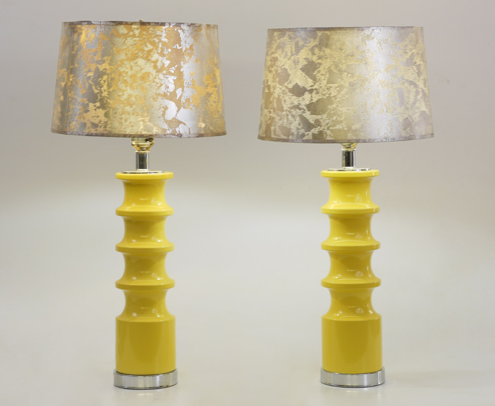 Appraisal: PAIR OF MID-CENTURY MODERN YELLOW LAMPS WITH SHADES Shaped ceramic