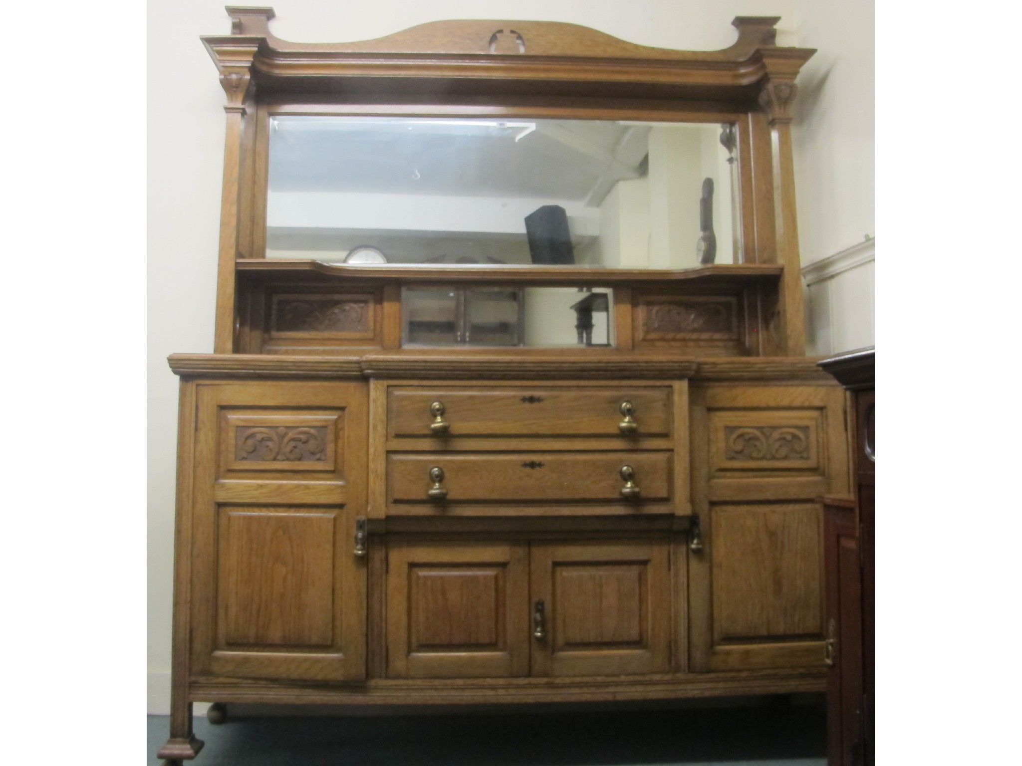 Appraisal: A large oak mirrored back sideboard