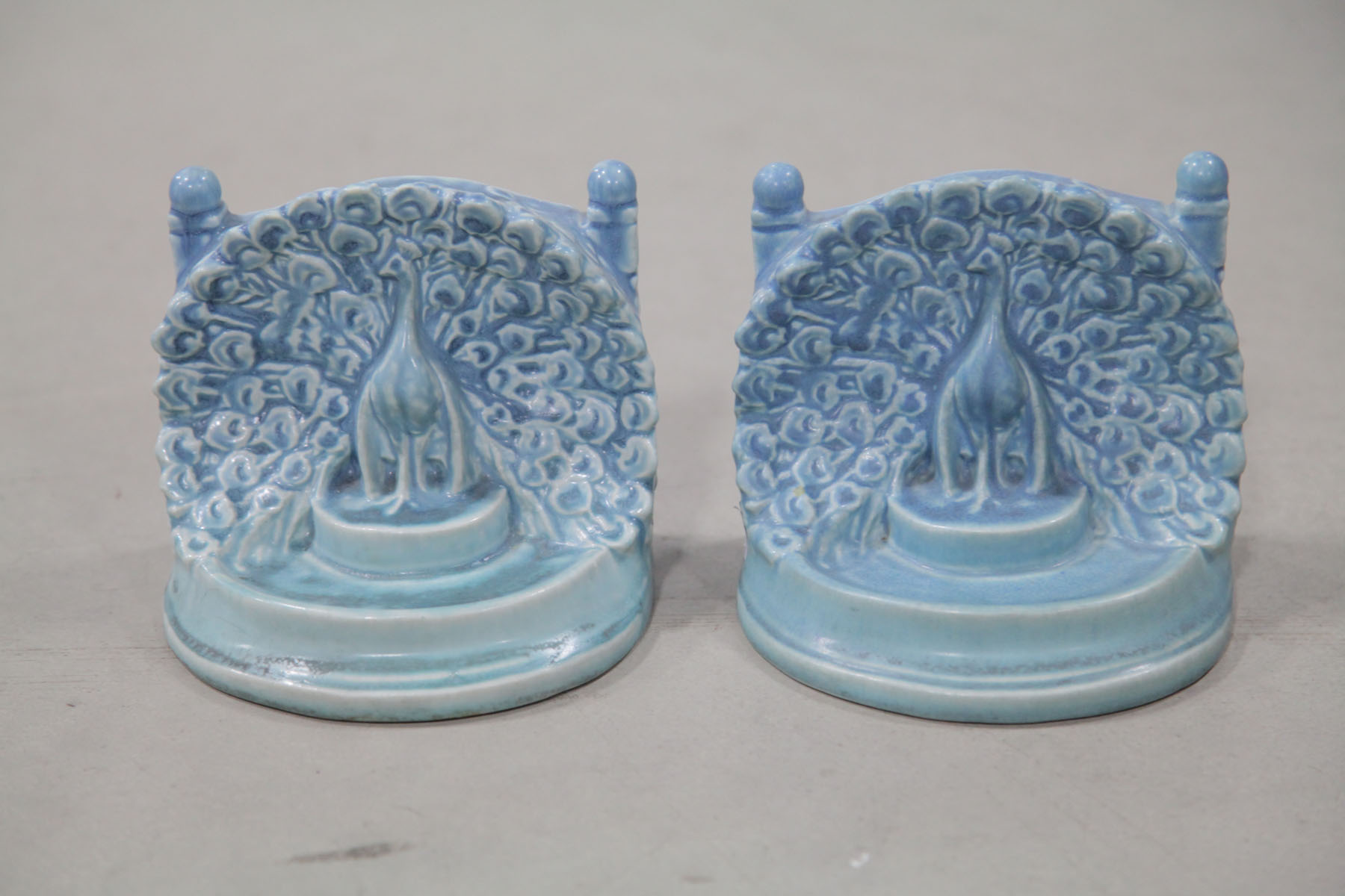 Appraisal: PAIR OF ROOKWOOD BOOKENDS Ohio Molded bookends in blue depicting