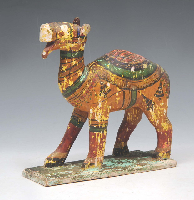 Appraisal: AN INDIAN CARVED WOODEN FIGURE of a camel painted brightly