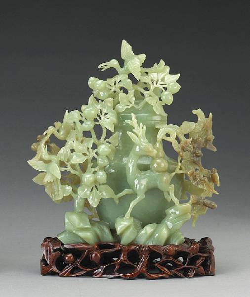 Appraisal: An olive green jade covered vase with auspicious animals th