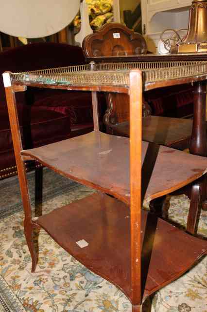 Appraisal: A CONTINENTAL MAHOGANY THREE TIER ETAGERE with galleried top and