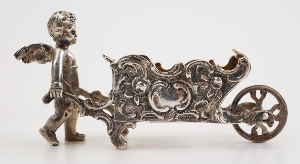 Appraisal: Miniature German sterling cherub and wheelbarrow ornately engraved Hallmarked on