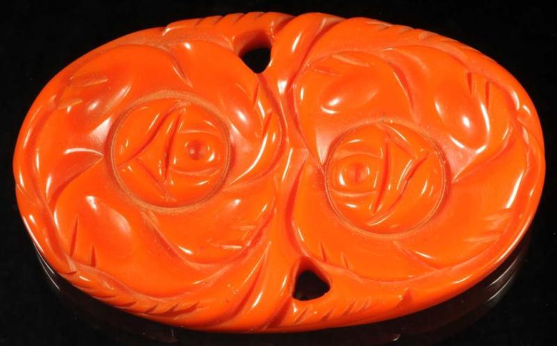 Appraisal: Bakelite Carved Orange Pin Description Depicts two large flowers Condition