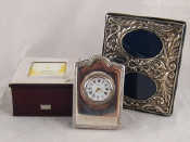 Appraisal: A silver faced quartz clock with strut back x cm