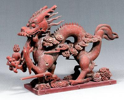 Appraisal: Large Chinese red lacquer dragon striding through clouds with flaming