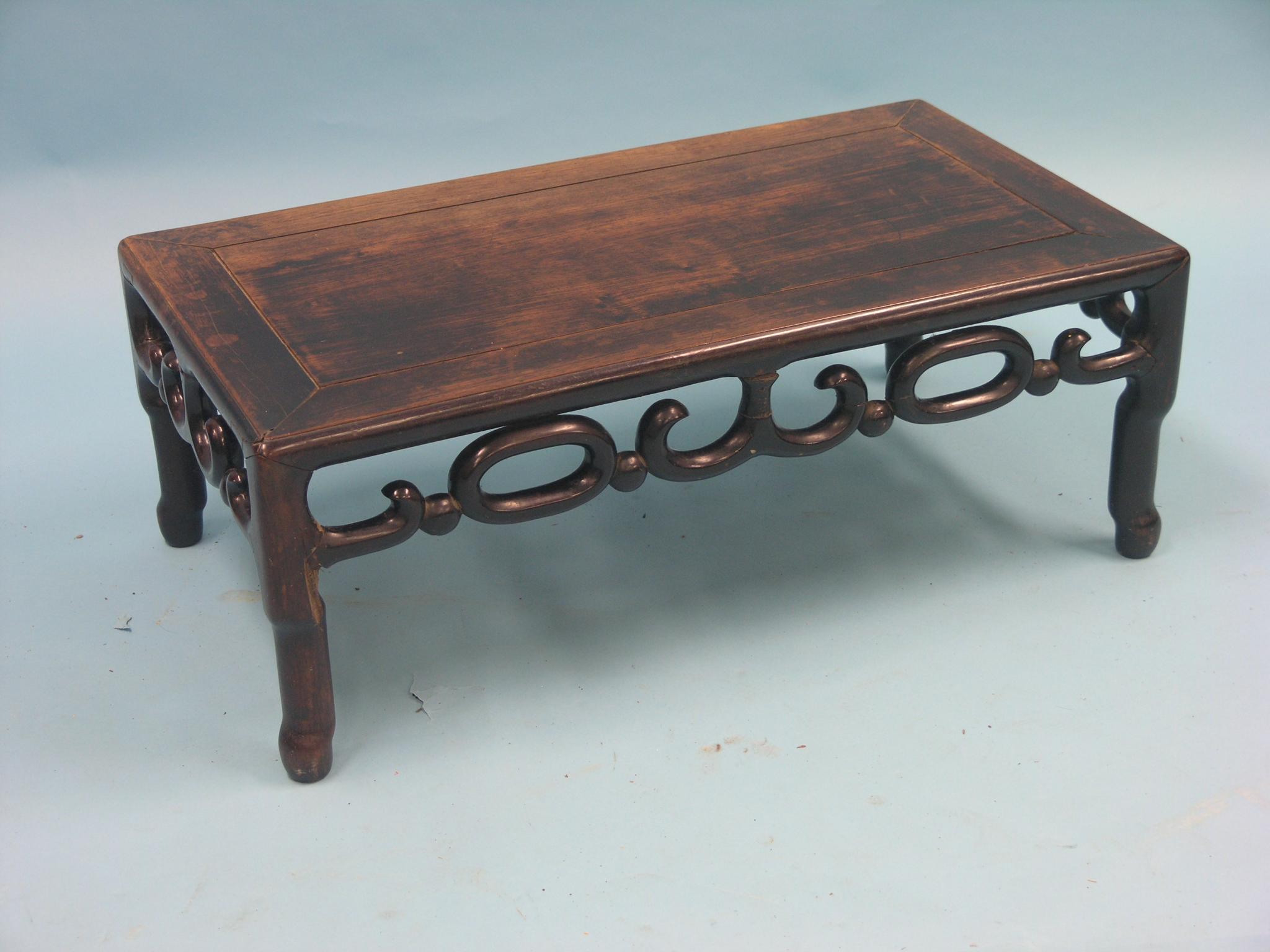 Appraisal: A Chinese rosewood-family coffee table rectangular top above open scroll