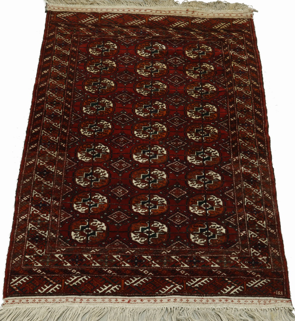 Appraisal: AFGHAN BOKHARA STYLE RUG Three columns of nine octagonal guls