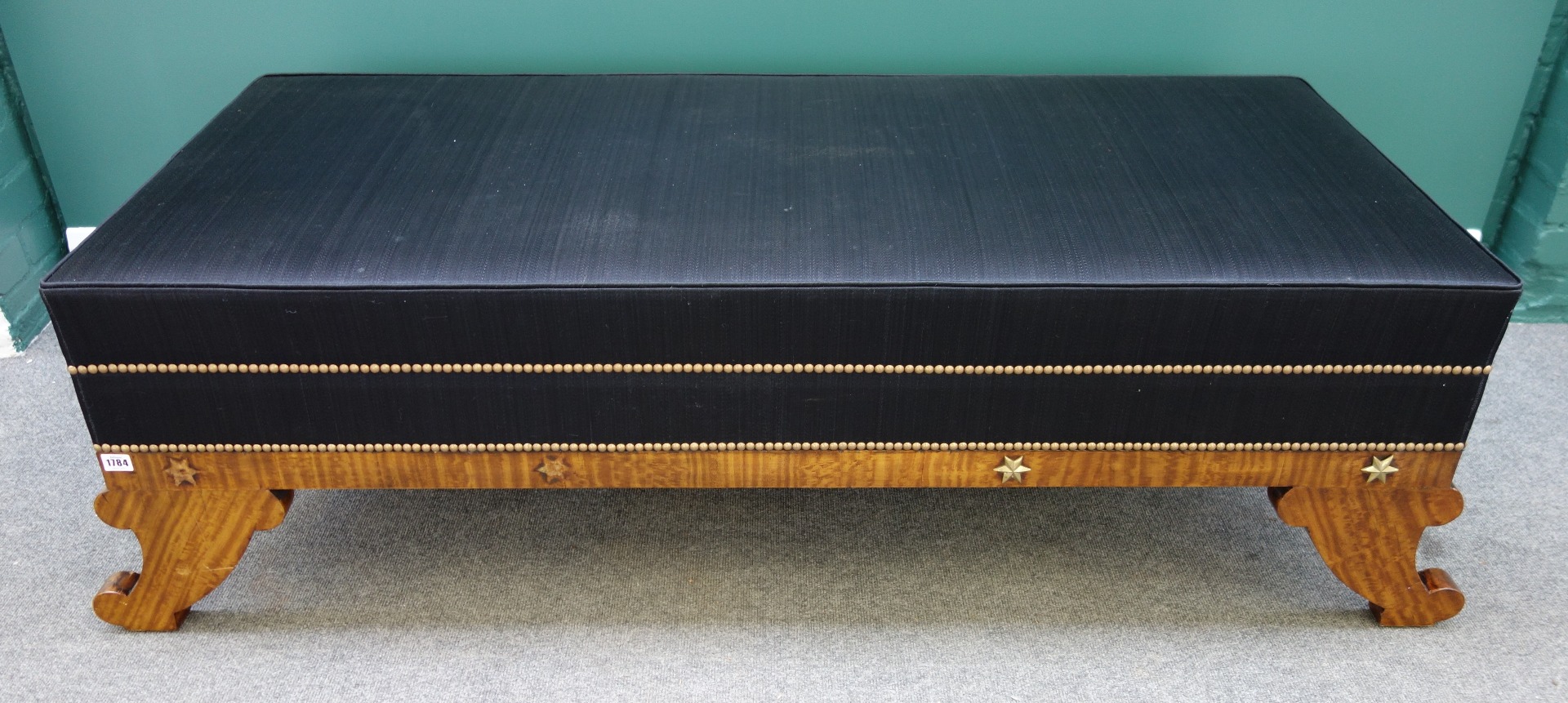 Appraisal: A large Empire style gilt metal mounted satinwood rectangular footstool