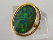 Appraisal: A carat gold and opal doublet ring the central oval