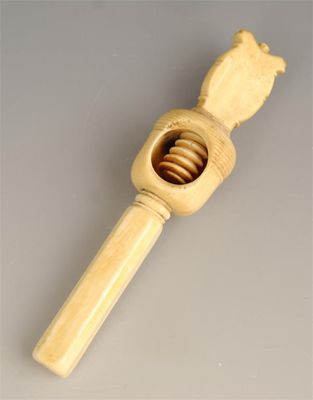 Appraisal: A th century ivory nutcracker with a faceted handle and