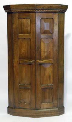 Appraisal: AN ARTS AND CRAFTS WALNUT STANDING CORNER CUPBOARD in the