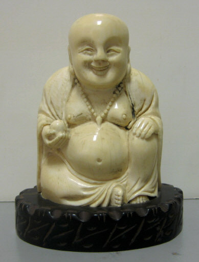 Appraisal: CARVED IVORY FIGURE OF A SMILING BUDDHA Seated position holding