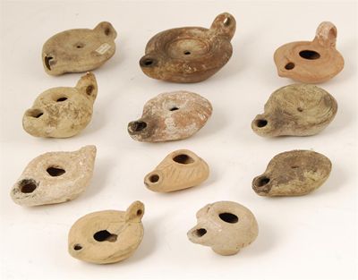 Appraisal: A small collection of eleven pottery oil lamps of typical