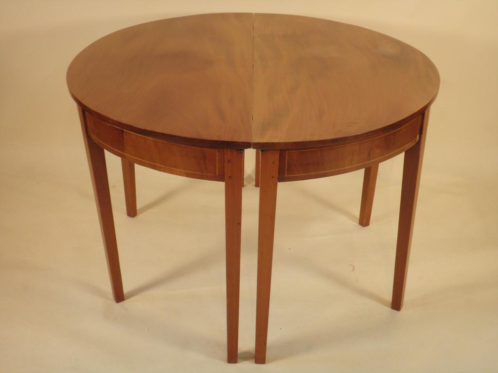 Appraisal: A George III mahogany and boxwood strung extending dining table