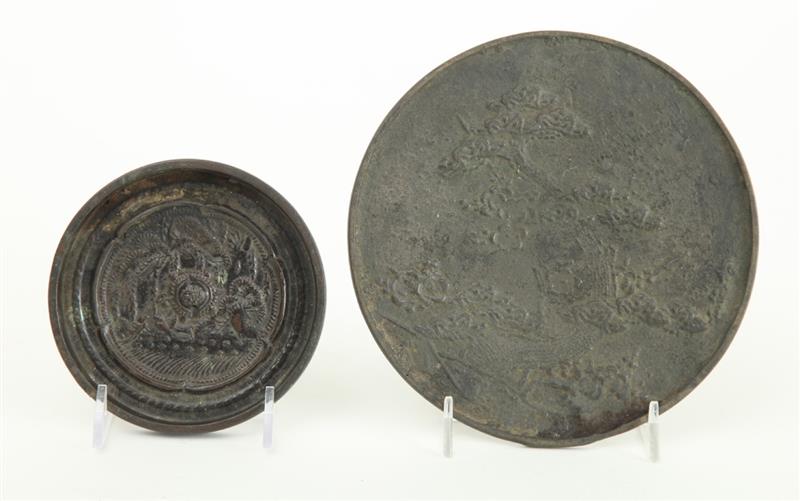 Appraisal: TWO CHINESE ARCHAIC BRONZE MIRRORS The larger relief modeled with