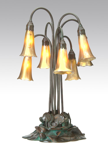 Appraisal: TIFFANY STUDIOS Seven-light Lily lamp with gold Favrile shades on