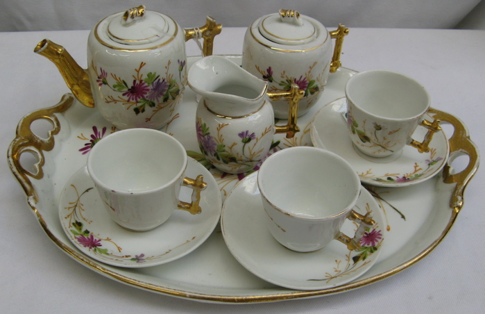 Appraisal: TEN PIECE PORCELAIN HAND PAINTED CHILD'S TEA SET colorful floral