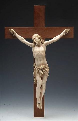 Appraisal: A CONTINENTAL IVORY CORPUS CHRISTI fixed to a wooden cross