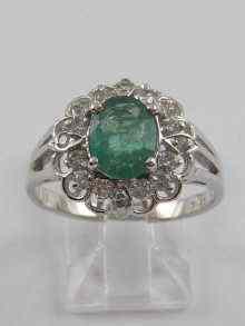 Appraisal: A white metal marked ct diamond and emerald cluster ring