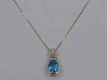 Appraisal: A hallmarked ct white gold diamond and blue topaz pendant