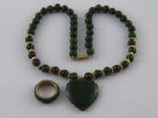 Appraisal: A nephrite jade necklace with gilt metal tests silver clasp